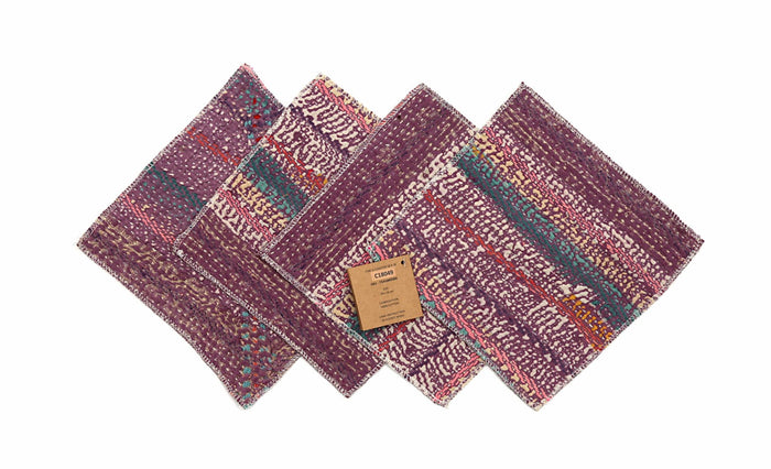 Set of 4 coasters 18x18 cm in purple/dark burgundy with colorful patterns, turquoise and orange details as well as white polka dot pattern and visible white edges